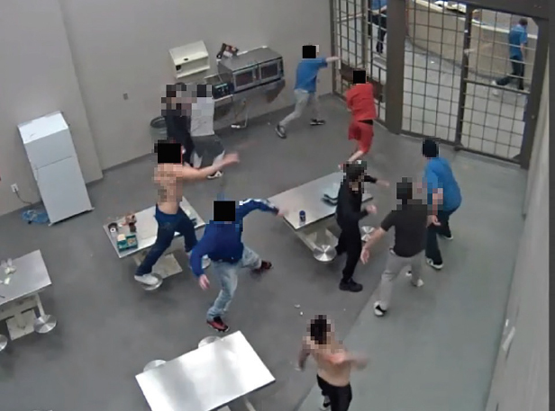 A CCTV capture showing inmates throwing food at protected status inmates in Edmonton Institution