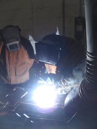 Photo of individuals participating in CORCAN welder training at Collins Bay Institution