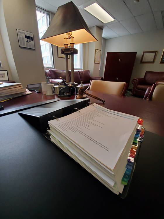 Photo of binder containing the 2020-21 corporate reporting requirements for the Office of the Correctional Investigator.