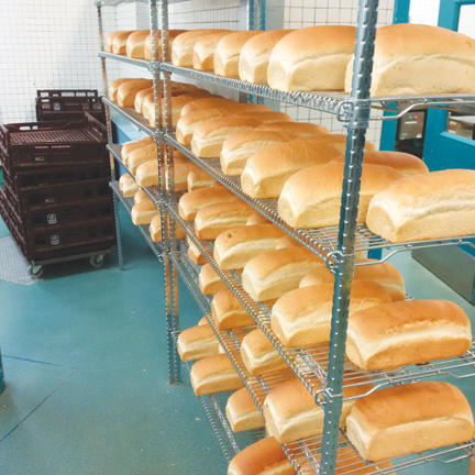 Photo of shelves of freshly baked loaves of bread