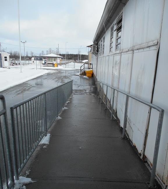 A picture of an accessible ramp leading to a building at a federal institution.